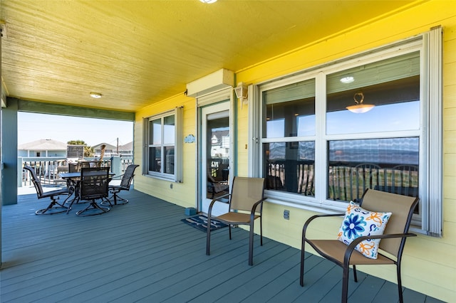 wooden deck featuring outdoor dining area