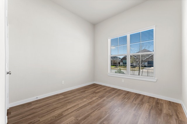 unfurnished room featuring baseboards and wood finished floors