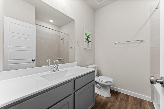 bathroom featuring vanity, wood finished floors, toilet, and baseboards