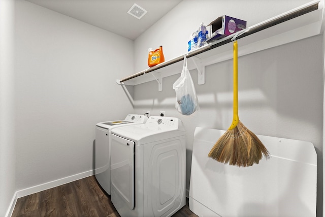 clothes washing area with laundry area, visible vents, baseboards, dark wood-style floors, and separate washer and dryer