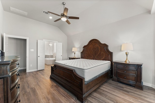 bedroom with lofted ceiling, visible vents, baseboards, and wood finished floors