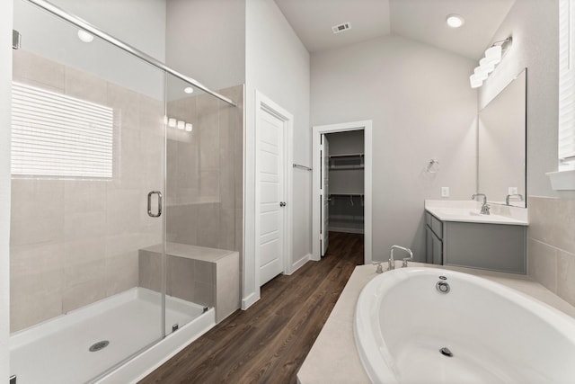 full bathroom featuring lofted ceiling, a stall shower, visible vents, and a garden tub