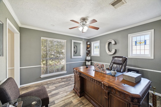5502 Enchanted Timbers Dr, Humble, TX 77346 - office area featuring a ceiling fan, wood finished floors, a textured ceiling, crown molding, and baseboards