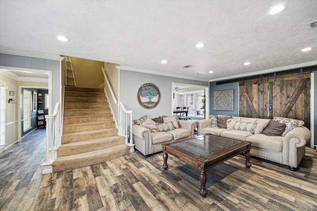 5502 Enchanted Timbers Dr, Humble, TX 77346 - living room featuring crown molding, wood finished floors, a textured ceiling, stairs, and recessed lighting