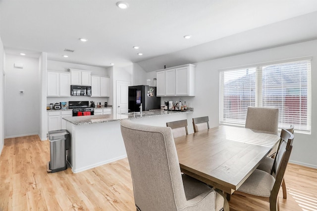 dining room with light wood-style flooring, baseboards, and recessed lighting