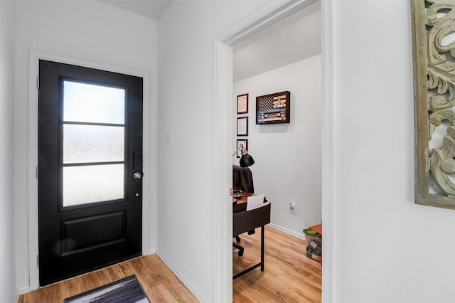 entryway with baseboards and light wood-style floors