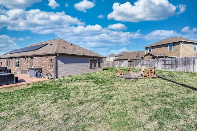 view of yard featuring an outdoor fire pit, a patio area, a fenced backyard, and cooling unit