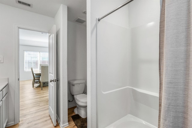 full bathroom featuring toilet, visible vents, wood finished floors, and vanity