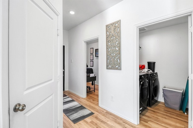 corridor featuring light wood finished floors, washing machine and dryer, baseboards, and recessed lighting