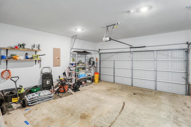 garage featuring electric panel and a garage door opener