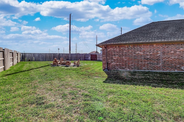 view of yard with an outdoor fire pit and a fenced backyard