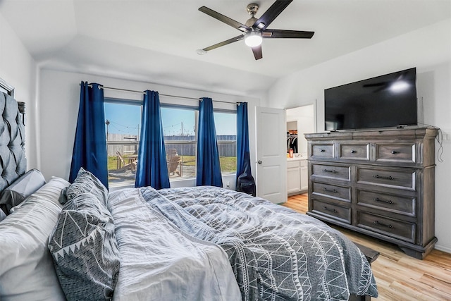 bedroom with a ceiling fan, lofted ceiling, and light wood finished floors