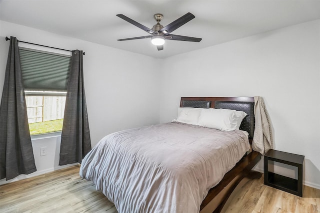 bedroom with a ceiling fan and wood finished floors