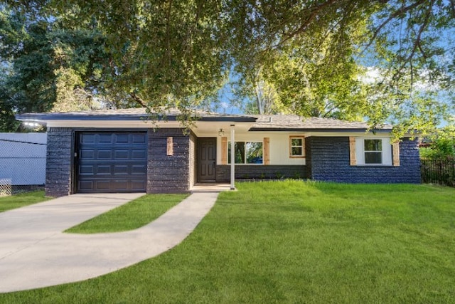 ranch-style home featuring a garage, driveway, a front yard, and fence