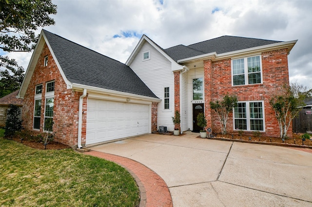 traditional home featuring a shingled roof, concrete driveway, and brick siding