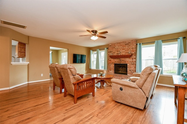 living area with a healthy amount of sunlight, light wood-style flooring, and visible vents