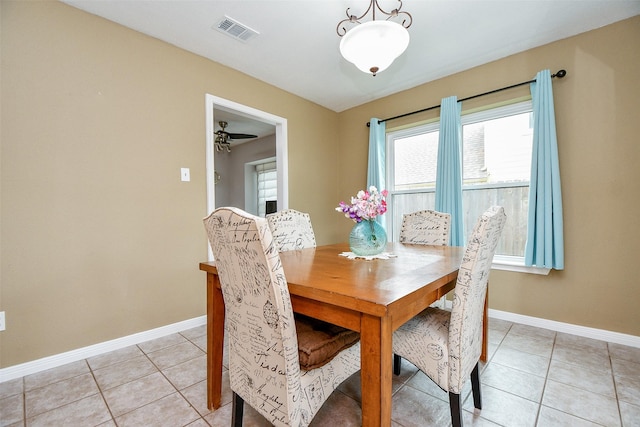 dining area featuring light tile patterned floors, visible vents, and baseboards