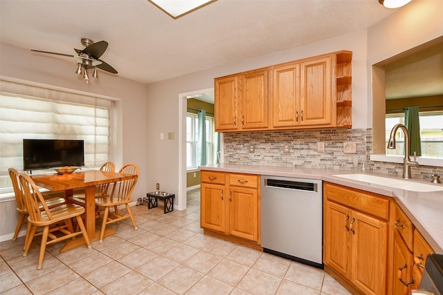 kitchen with decorative backsplash, light countertops, stainless steel dishwasher, open shelves, and a sink