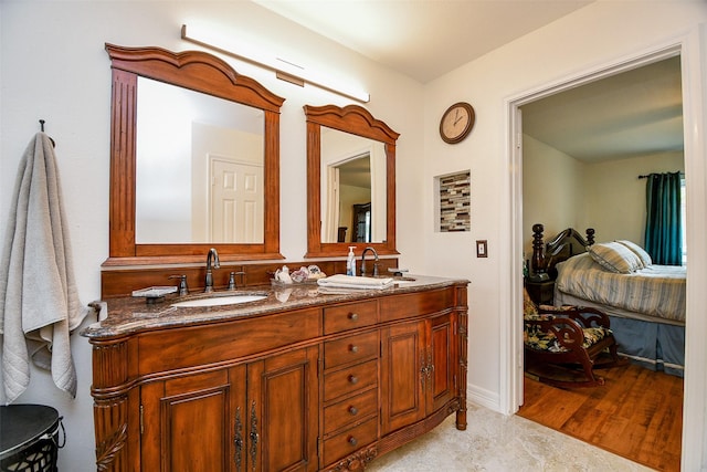 full bathroom with a sink and double vanity