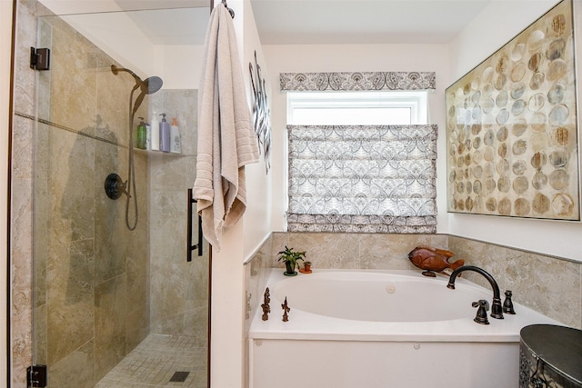 bathroom featuring a stall shower and a garden tub