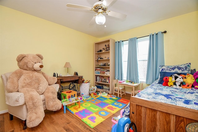 bedroom with ceiling fan and wood finished floors