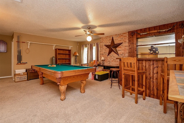 recreation room with a textured ceiling, carpet floors, and a bar