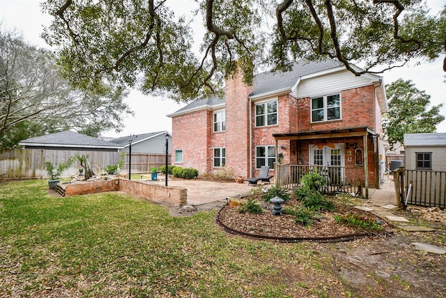 back of house featuring brick siding, a patio, a chimney, and a fenced backyard