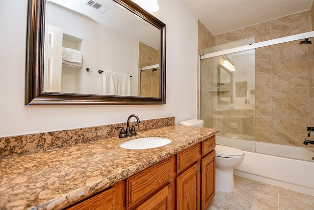 full bathroom with toilet, visible vents, bath / shower combo with glass door, and vanity