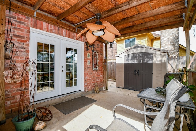 view of patio / terrace featuring ceiling fan, a shed, french doors, and an outdoor structure