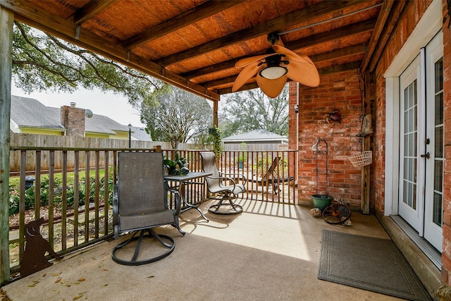 view of patio / terrace with french doors, ceiling fan, and fence