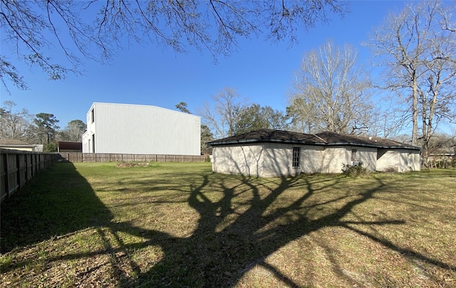 view of yard with an outbuilding, an outdoor structure, and fence