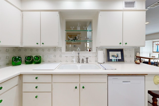 kitchen with visible vents, white dishwasher, a sink, and white cabinetry