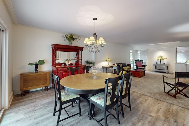 dining space featuring a chandelier and light wood finished floors