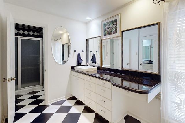 bathroom with baseboards, tile patterned floors, vanity, a shower stall, and recessed lighting
