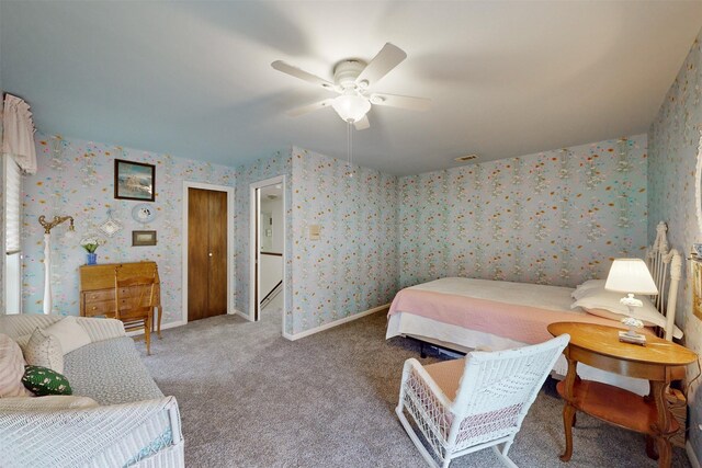 carpeted bedroom with baseboards, a ceiling fan, visible vents, and wallpapered walls