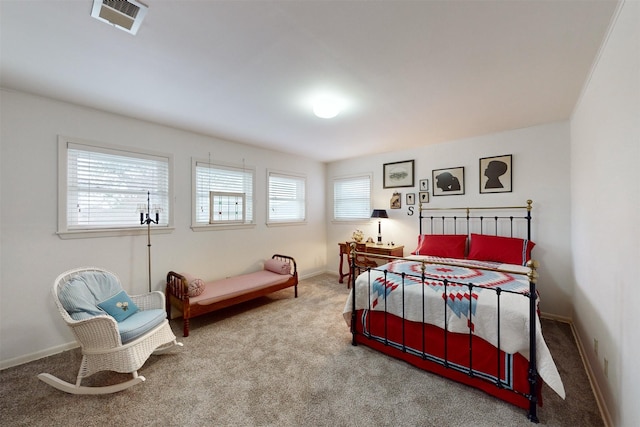 carpeted bedroom featuring visible vents and baseboards