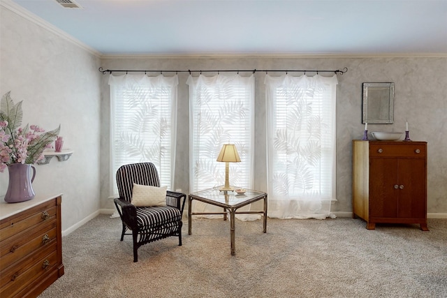 sitting room with a healthy amount of sunlight, baseboards, light carpet, and ornamental molding