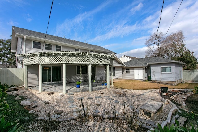 rear view of property with fence and a patio