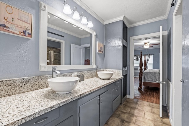 full bathroom featuring crown molding, connected bathroom, a sink, and double vanity