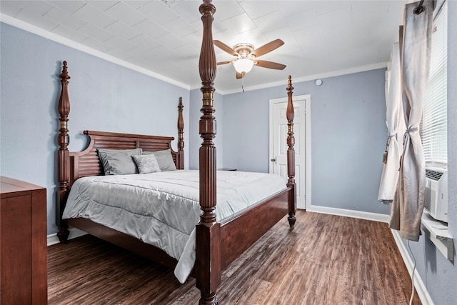 bedroom with baseboards, wood finished floors, and crown molding