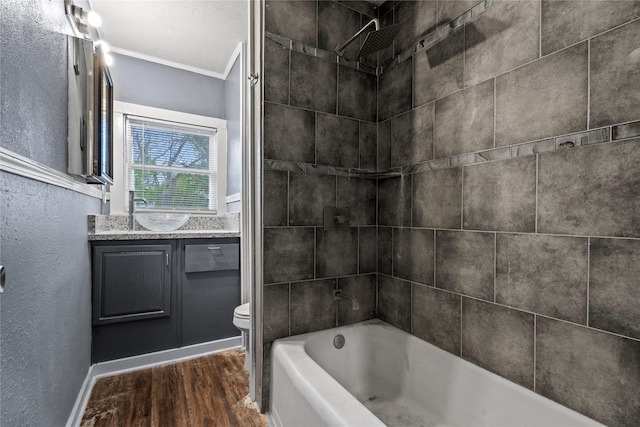 full bath with a textured wall, toilet, wood finished floors, vanity, and  shower combination