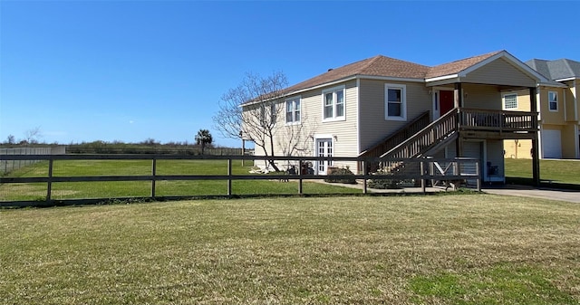 exterior space with a yard, fence, and stairs