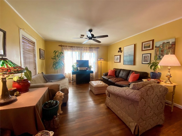 living room with ornamental molding, ceiling fan, and wood finished floors