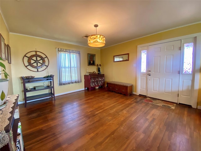 entryway with baseboards, plenty of natural light, wood finished floors, and crown molding