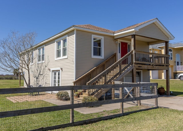 view of front of property featuring a front lawn and stairway