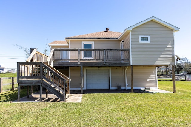 rear view of house with stairs, a yard, a deck, and an attached garage