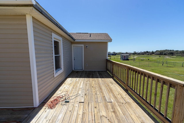 wooden terrace featuring a lawn