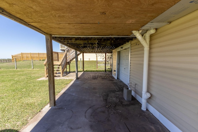 view of patio featuring fence and stairway