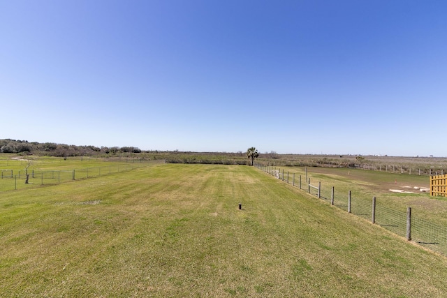 view of yard featuring a rural view and fence