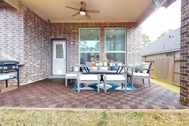 view of patio featuring fence, an outdoor living space, a ceiling fan, and area for grilling